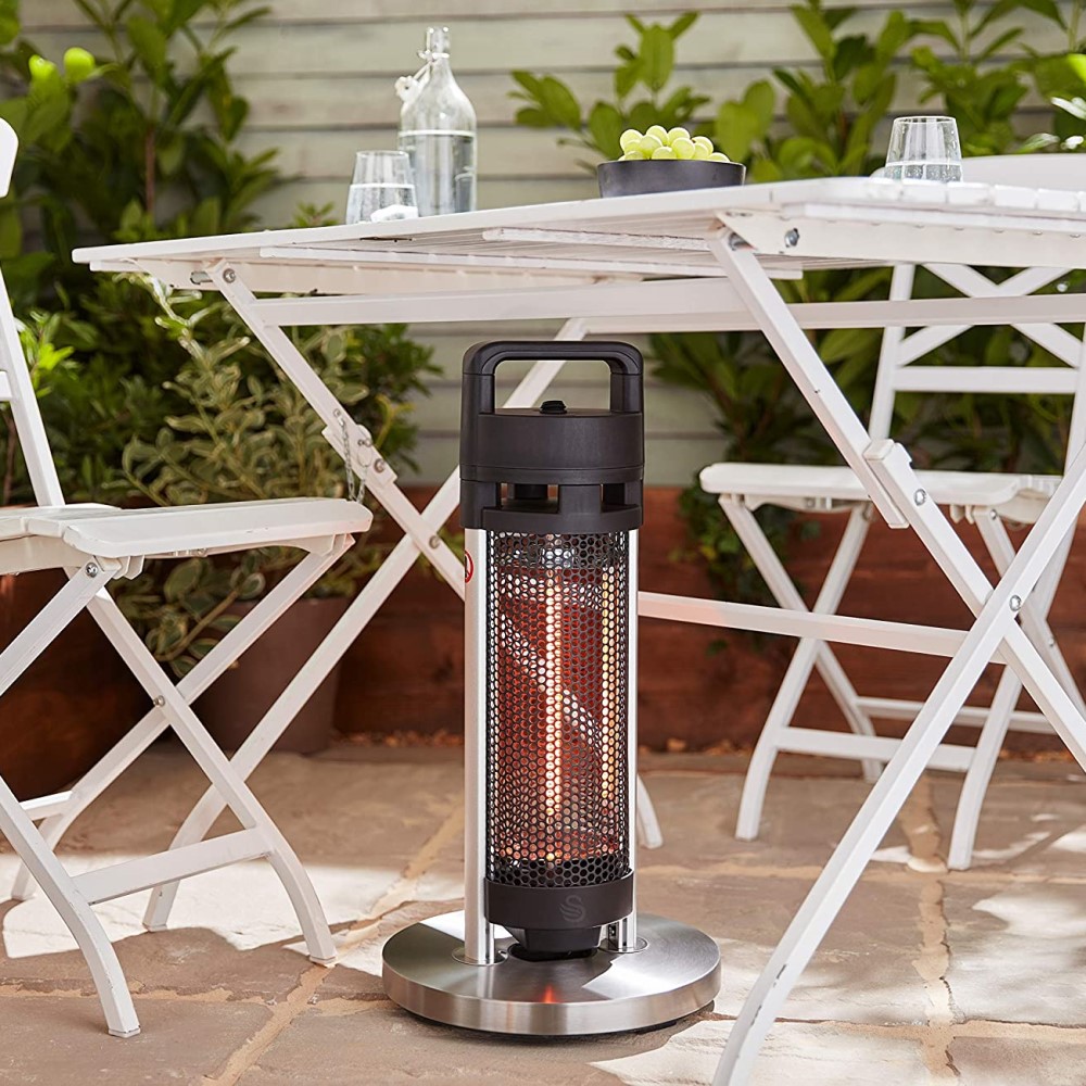 Paved garden patio with a table and a patio heater