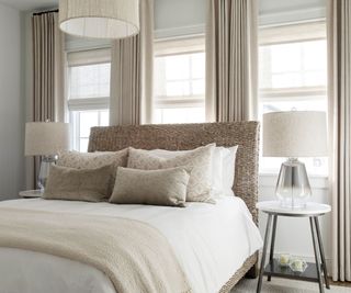 Wicker bed, white lampshades, cream curtains