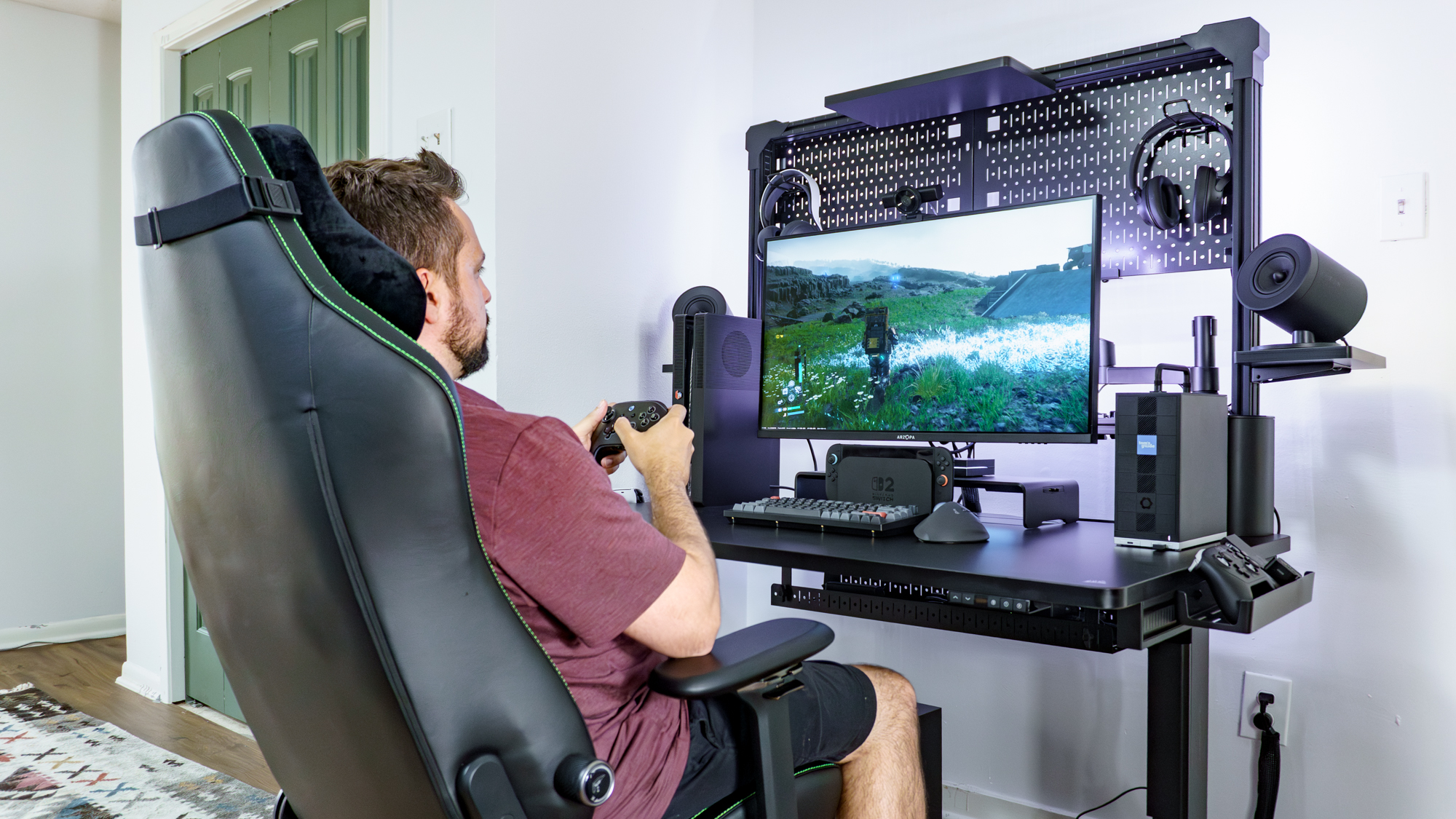 A person slightly leaned back playing Death Stranding 2 on PC in the Razer Iskur V2 NewGen gaming chair
