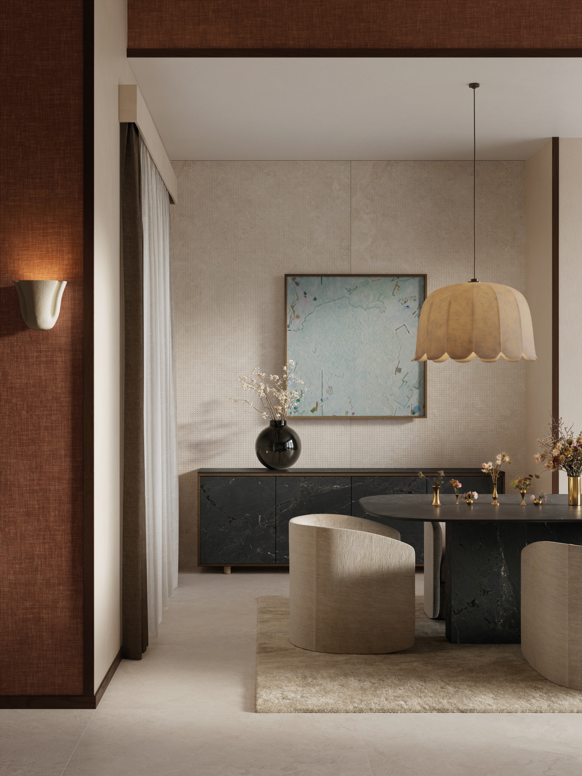 A beige-tinted living room with a floral-inspired pendant light in paper, an abstract pale blue artwork, a sculptural stone black table, white sculptural seats, textile walls, and fuzzy decor.
