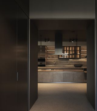 A view of the VVD kitchen by Vincent Van Duysen, on the showroom's first floor. Its rich material palette includes steel base units doors, ceppo worktops with integrated sink, graphite oak snack worktop with a pewter structure and matt lacquered lead columnns 
