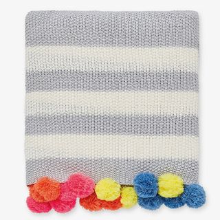 colourful pom pom and cotton blanket in grey and white colour