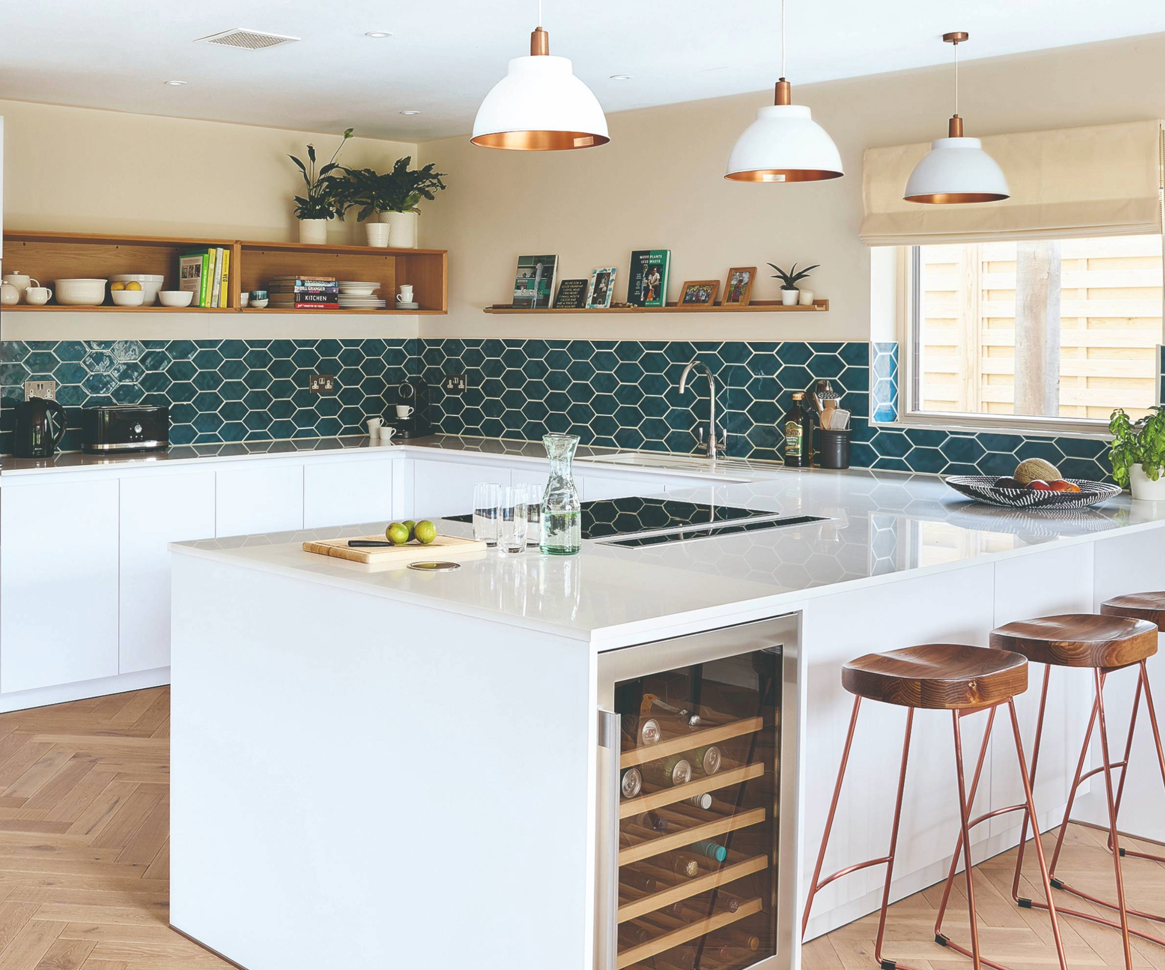 Kitchen with blue hexagon tiles and white worktops