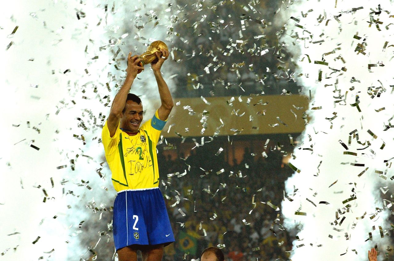 Brazil captain Cafu is showered with confetti as he lifts the World Cup trophy following a win over Germany in the 2002 final