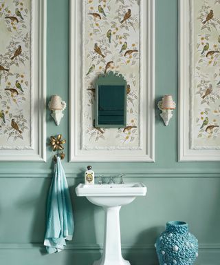 duck egg blue panelled bathroom walls with white wallpaper with bird pattern in wall panelled sections above the sink