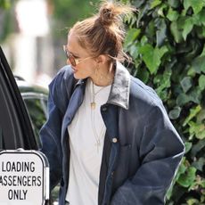 Jennifer Lopez and daughter Emme after lunch at The Ivy in Los Angeles. J.Lo wore baggy blue jeans, a blue barn jacket, a white T-shirt, and a Christian Dior bag.