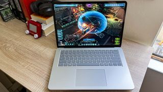 Microsoft Surface Laptop Studio 2 review unit on desk pkaying Warhammer 49k Chaos GateDaemon Hunters