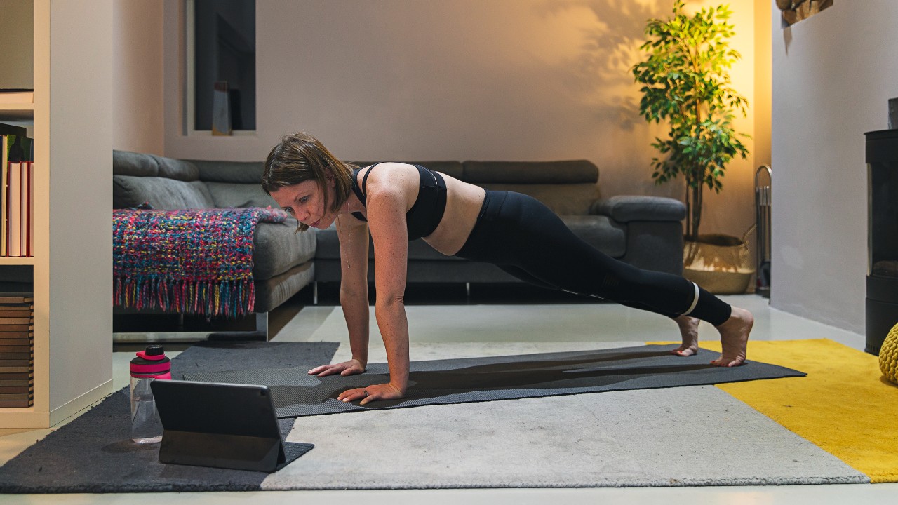A woman doing plank exercises at home