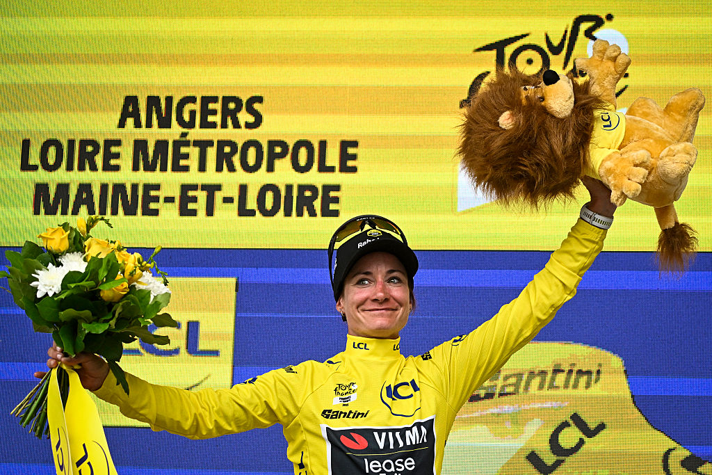 Team Visma | Lease a Bike's Dutch rider Marianne Vos celebrates on the podium with the overall leader's yellow jersey after the 3rd stage (out of 9) of the fourth edition of the Women's Tour de France cycling race, 163.5 km from La Gacilly to Angers, in Angers, western France on July 28, 2025. (Photo by JULIEN DE ROSA / AFP)
