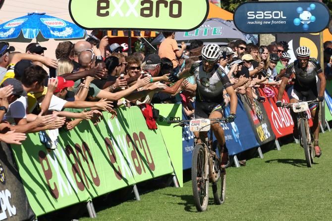 Christoph Sauser of Meerendal Songo Specialized celebrates with the spectators as he and his patner Frantisek Rabon finish 3rd during stage 6