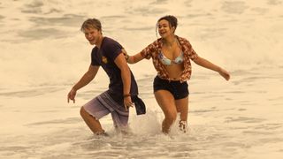 Rudy Pankow as JJ and Madison Bailey as Kiara, playing in the ocean, in 'Outer Banks' season 4