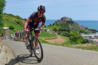 Russell Downing powers up the hill-climb stage of the Tour Series finale on Jersey. The Mont Orgueil Castle in Gorey forms the idyllic backdrop.