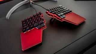 The Dygma Raise ergonomic split keyboard, in "Daredevil Red" color scheme.