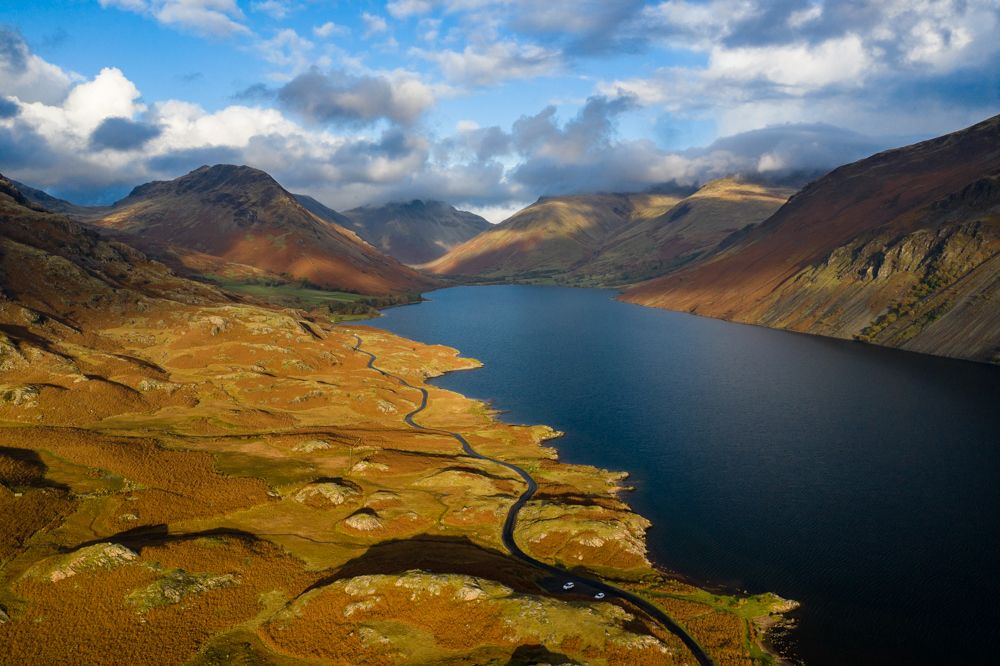 An aerial view of a lake running through a valley