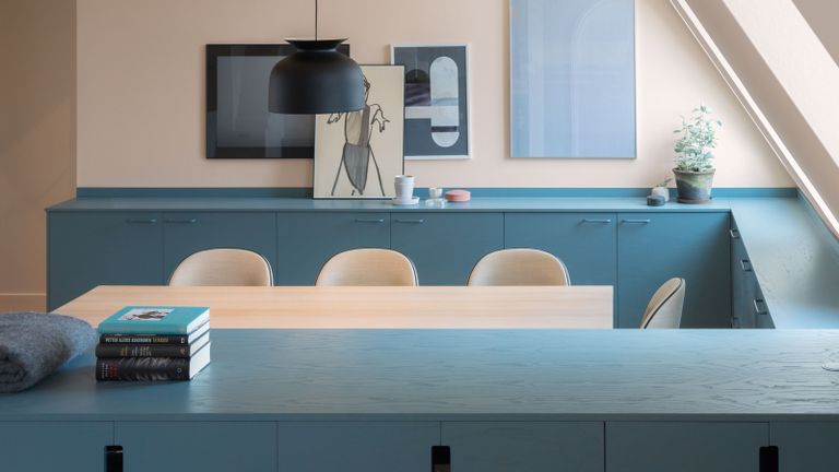 a light blue kitchen with a peach background
