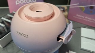 A close up of the Pococo Galaxy Projector with the disk draw slightly open