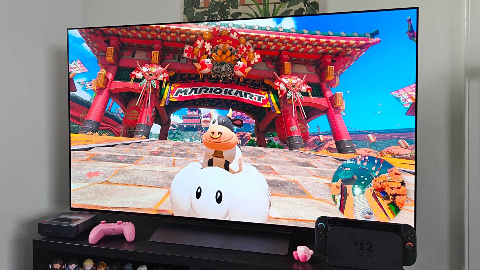 LG OLED C4 55-inch TV connected to Switch 2 with Mario Kart World gameplay on screen featuring Cow in cloud cart.