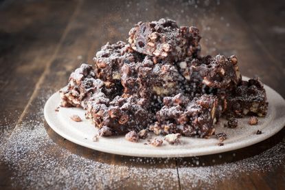 Maltesers rocky road bars on a plate with icing sugar dusting