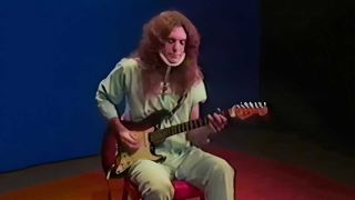 Allen Collins in hospital pyjamas playing guitar
