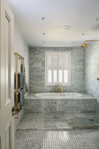 farmhouse shower and bath with beautiful natural stone tiles