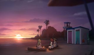 Three girls sit on a beach at sunset
