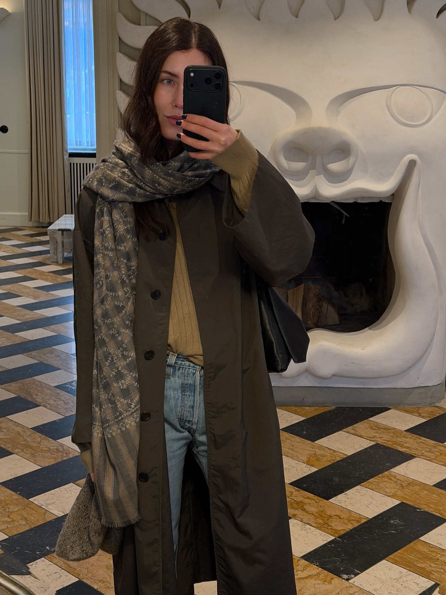 Fashion creator Annabel Rosendahl taking a mirror selfie with an inky manicure