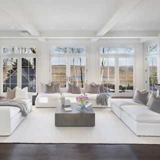 white soft furnishings blend into the white window panes and ceiling,