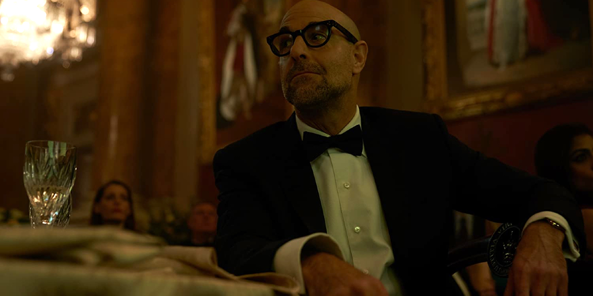 A Private War Stanley Tucci in a tuxedo, sitting at a table