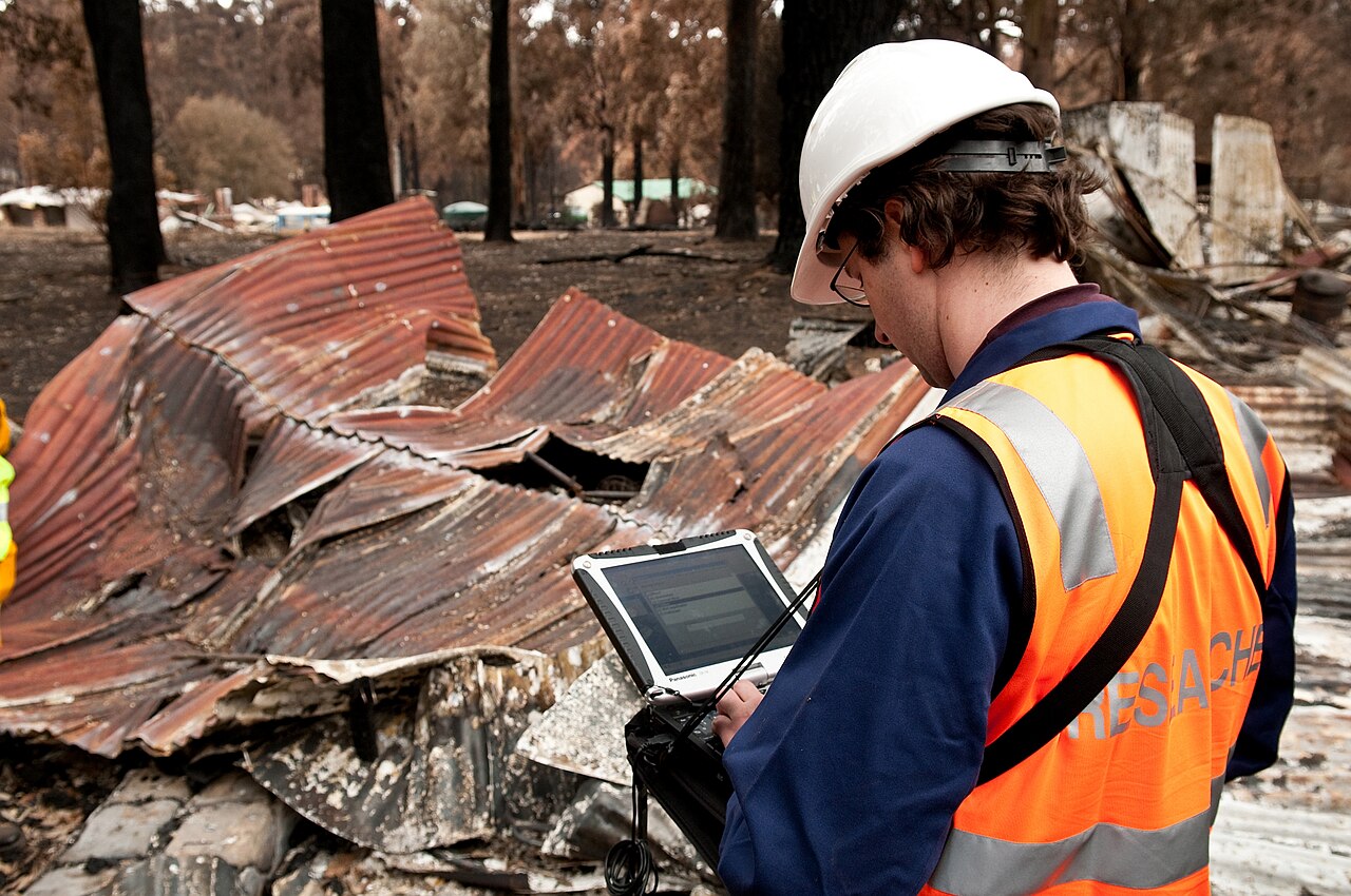 A Commonwealth Scientific and Industrial Research Organisation worker using a Panasonic Toughbook while assessing damage in the aftermath of the February 2009 bushfires in Victoria, Australia.