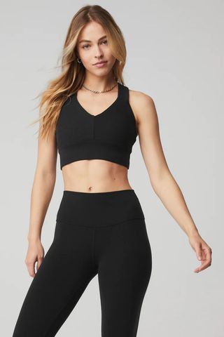 woman wearing black v-neck sports bra from the alo yoga sale
