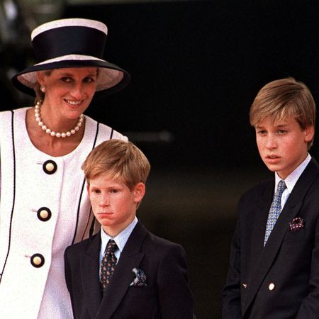 Princess Diana in a white blazer next to Prince William, Prince Harry and Prince Charles
