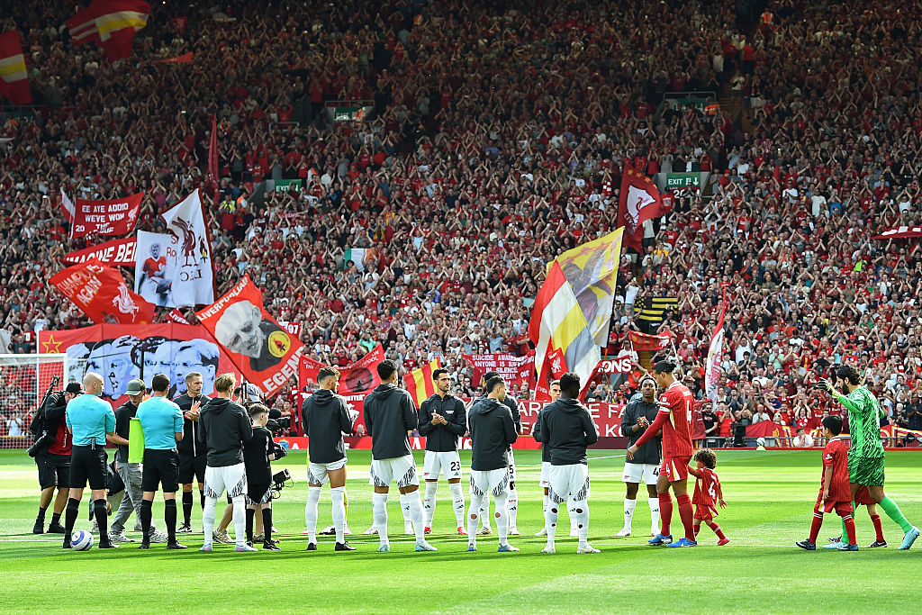 Liverpool's players receive a guard of honour from the Arsenal players ahead of kick-off in the English Premier League football match between Liverpool and Arsenal at Anfield in Liverpool, north west England on May 11, 2025.