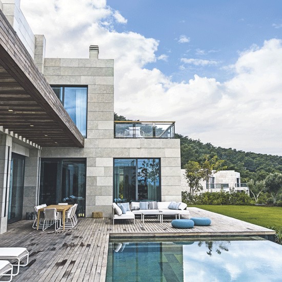 building with swimming pool and grass lawn