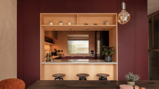 burgundy kitchen with wooden counters and walls