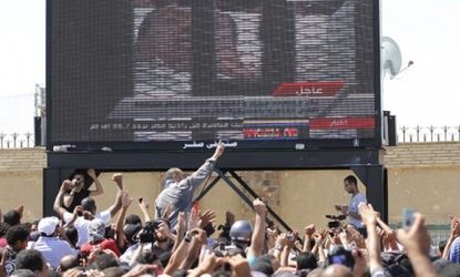 Egyptians watch Mubarak's trial unfold Wednesday: One lawyer requested a DNA test of the former president, saying the man lying in the hospital bed was not Mubarak.