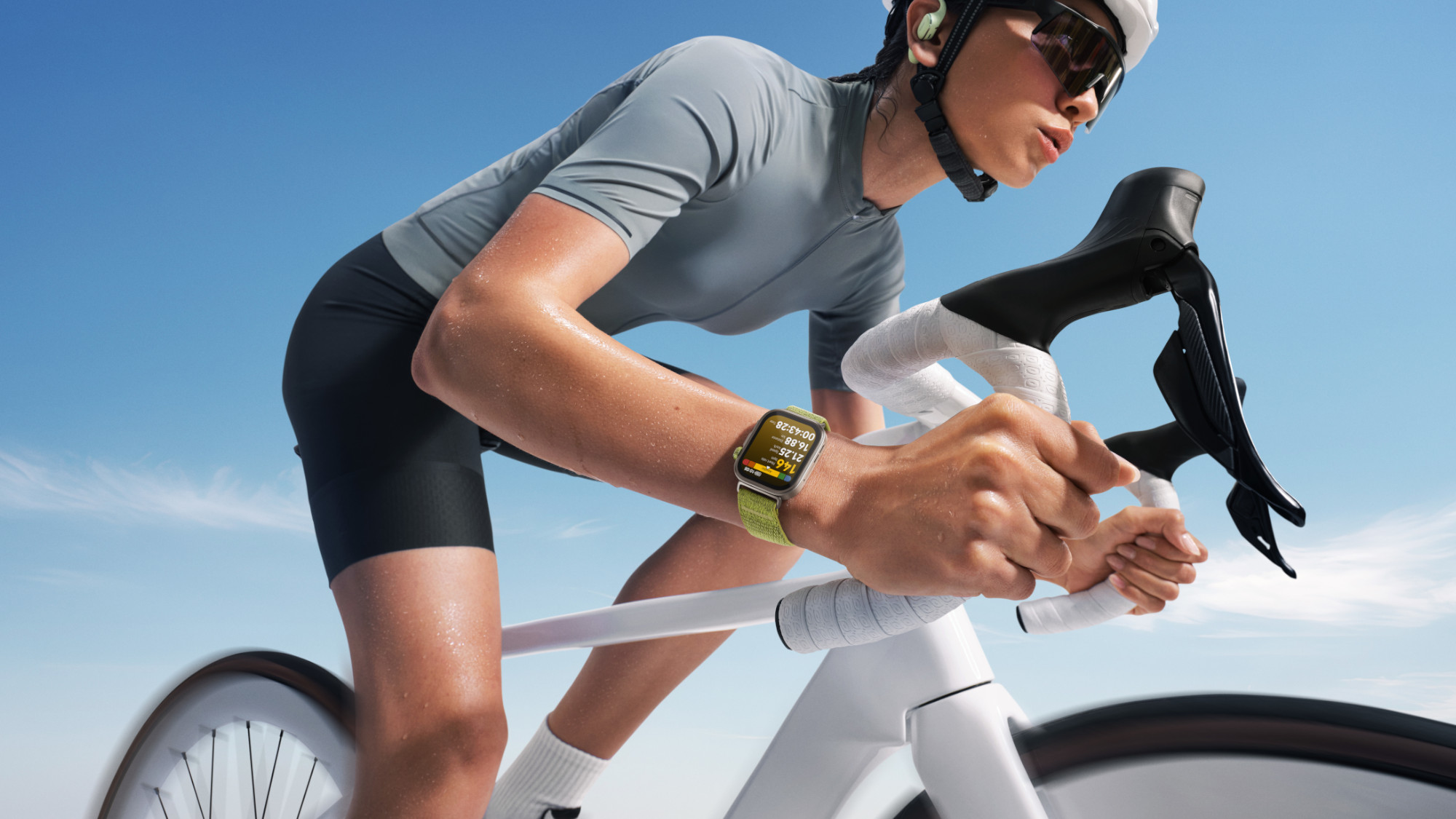 Woman riding bike with Huawei Watch Fit 4 Pro smartwatch on wrist.