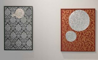 Two pieces of artwork on display. Left: A grey pattern. Right: A red pattern.