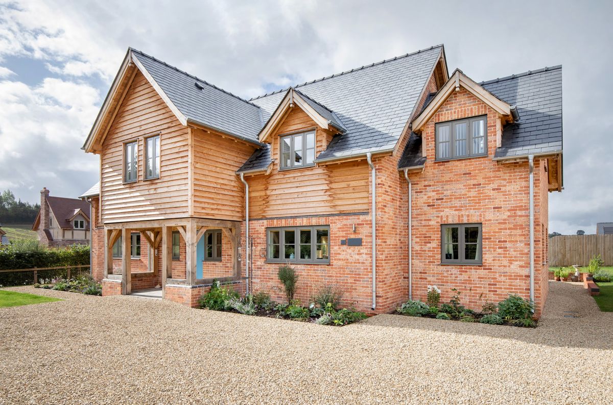 A red brick oak framed home with a large driveway