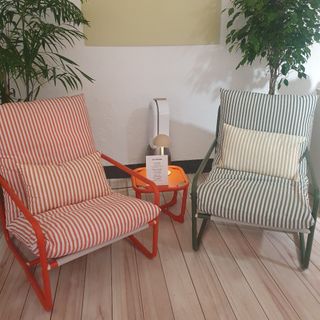 A set of two striped outdoor chairs in red and green stripes from the John Lewis spring/summer 2025 press showcase