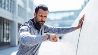 Unhappy man checking his GPS sports watch