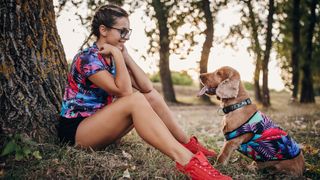 Woman and dog wearing matching outfits