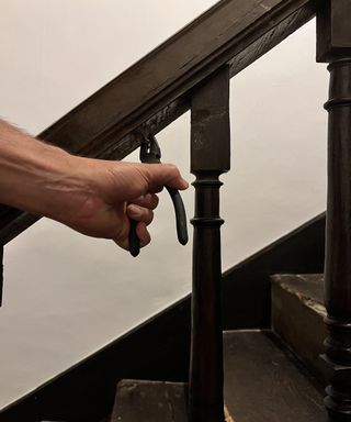 Pliers removing nails from staircase