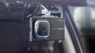 The Thinkware X1000 dash cam mounted inside a car windshield