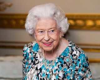 Queen Elizabeth II looks at the Birmingham 2022 Commonwealth Games Baton during the Baton Relay for Birmingham 2022