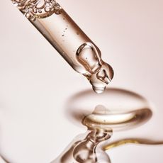 a pipette with clear liquid coming out