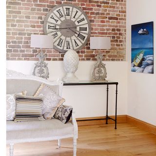 piano room with brick wall and clock