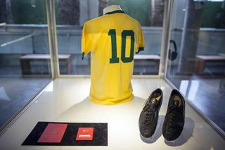 Pele's passport, #10 jersey and football boots on display at Pele Museum on June 20, 2014 in Santos, Brazil. The 4,000 square meter complex is located in Santo's old town and its construction cost was around 22 million USD. Recently opened for the public, Pele Museum contains more than 2,500 items related to the Brazilian star career , including trophies, jerseys and pictures of him with celebrities and world leaders.