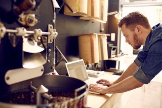 Small business owner checking his laptop