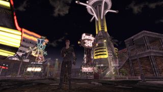 The Courier stands surrounded by the lights of New Vegas.