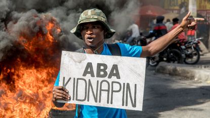 A Haitian man protests against rising gang violence on International Human Rights Day 2020